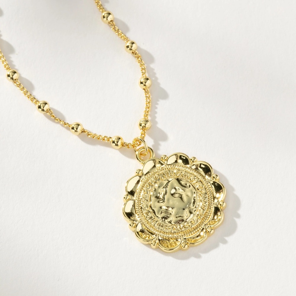Uncommon James Gold Necklace with Intricate Pendant and Decorative Chain